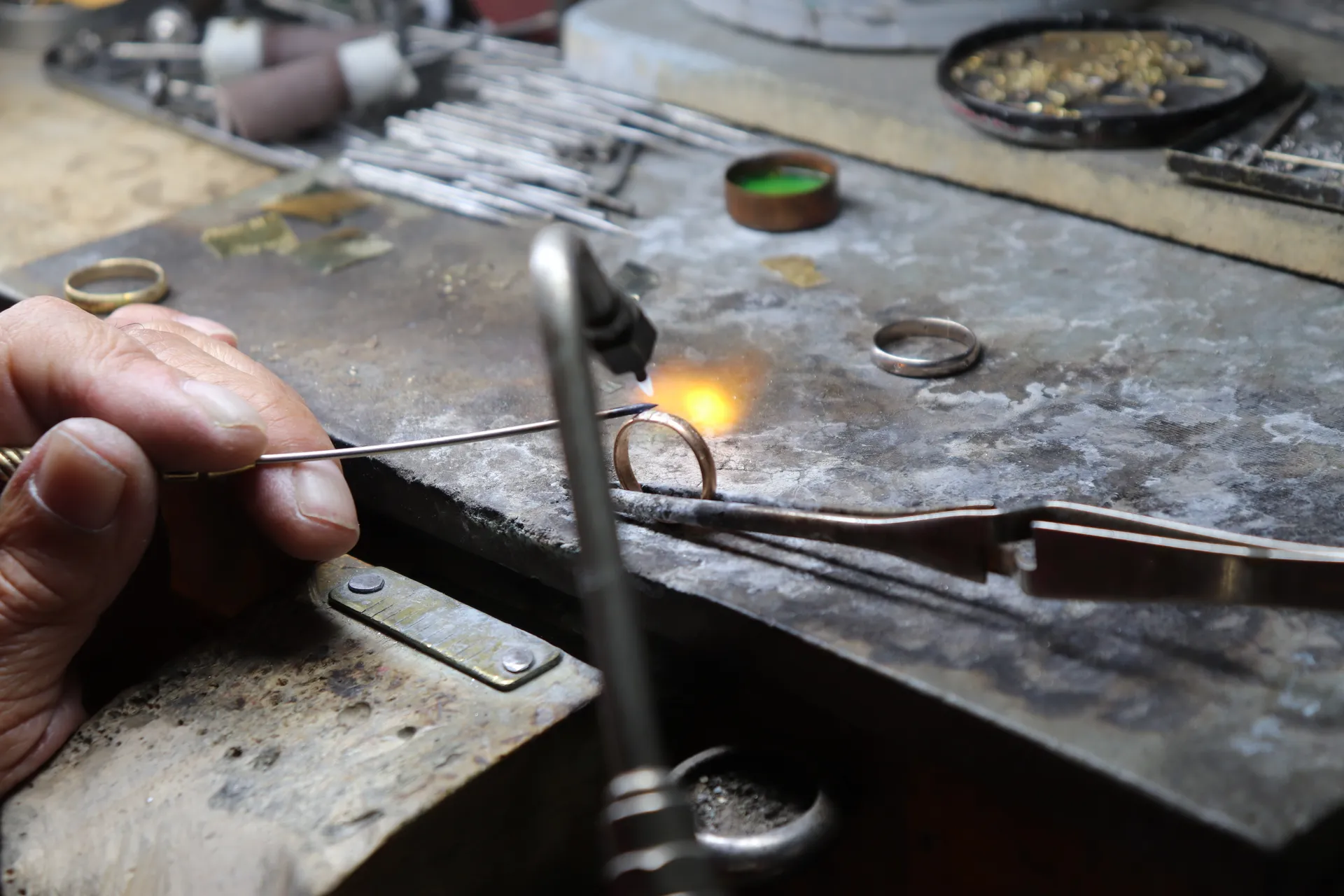 Jeweler soldering a ring